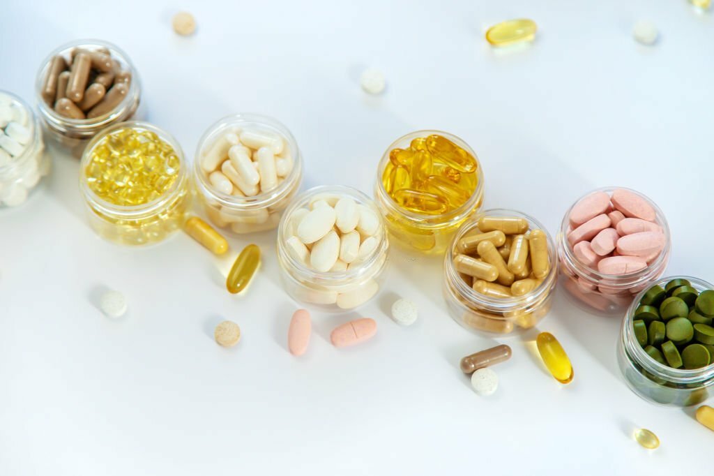 Supplements and vitamins on a white background. 